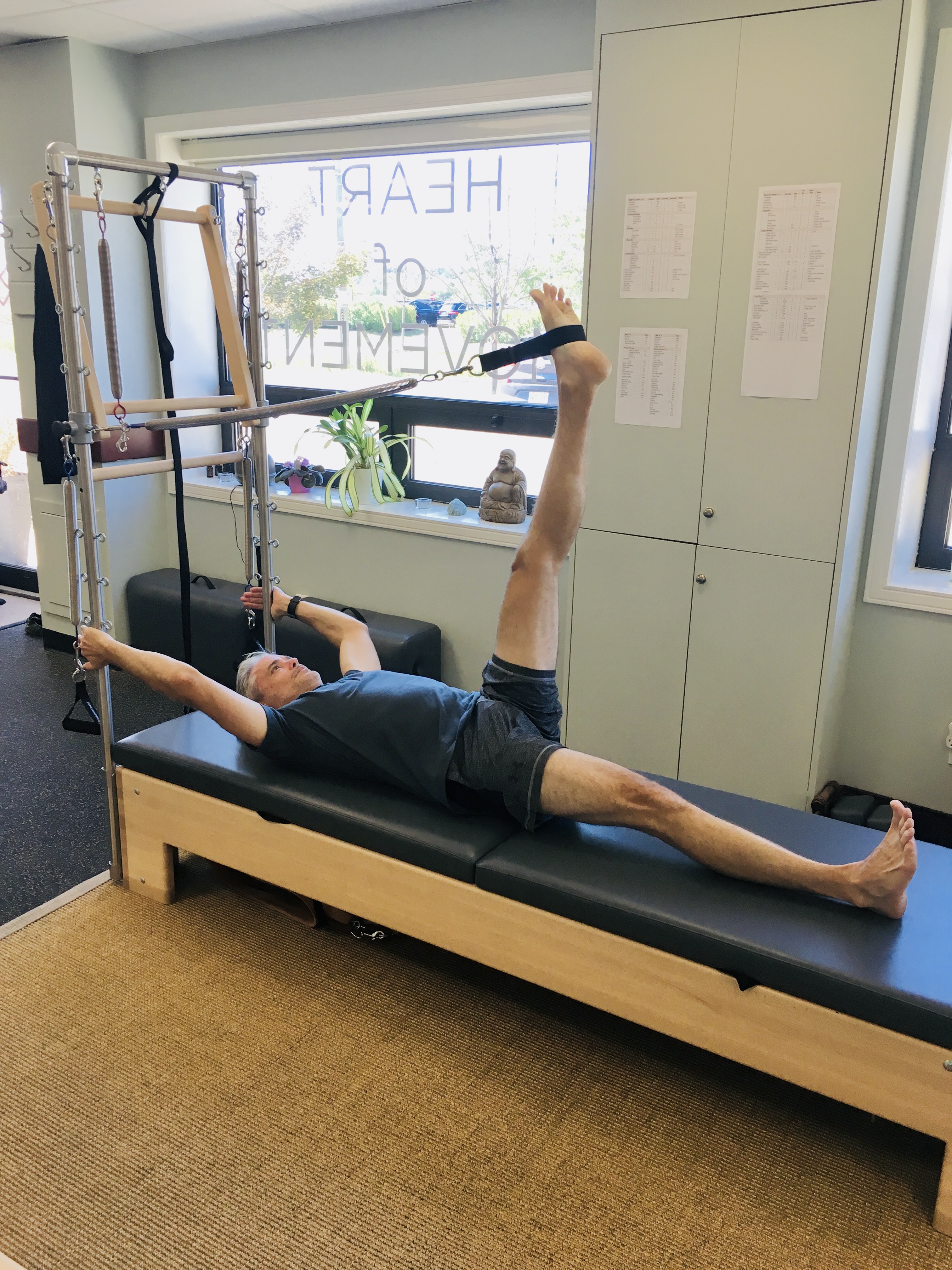 Rob Lee on a Pilates reformer at a studio